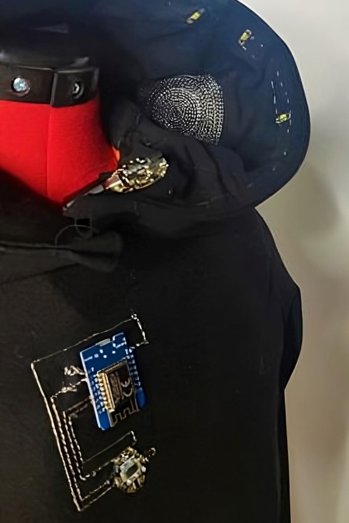 Close-up of the e-textile garment with embroidered sensors and electronics